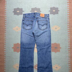 Vintage Levi’s skinner jeans low rise bootcut medium wash faded denim USA 32x33
